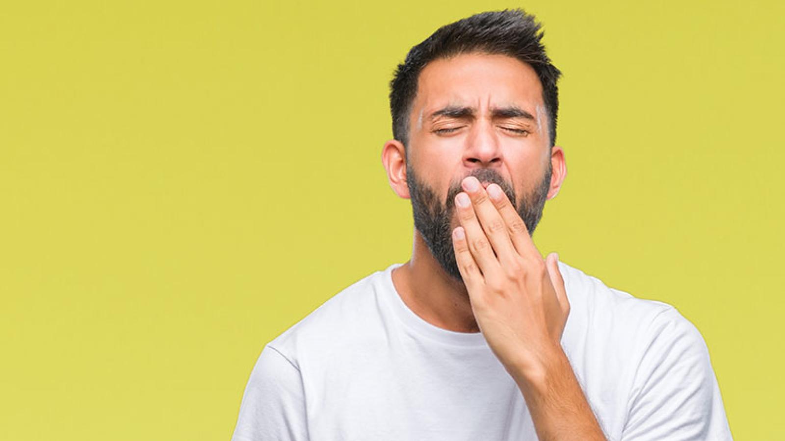 Young man yawning