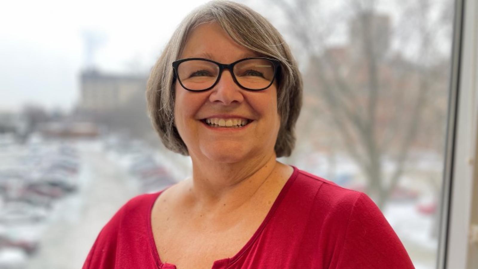 Shelley Messer stands in front of a window in winter.