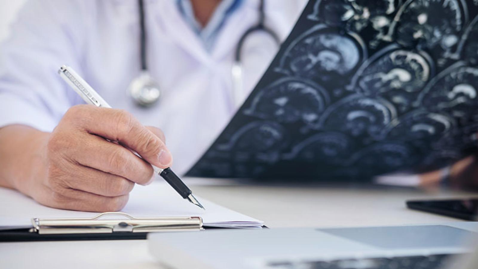 Neurologist examining brain scans