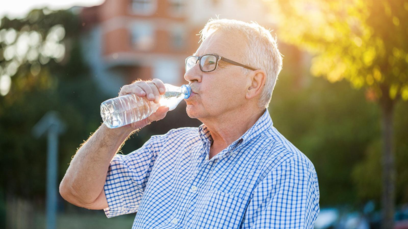 Older man drinks water