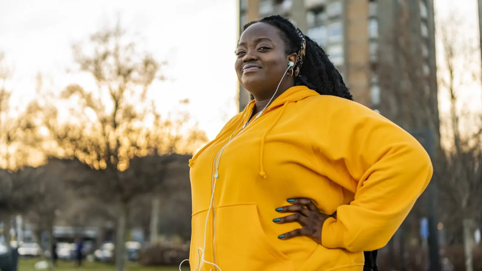 Woman outside exercising and smiling.