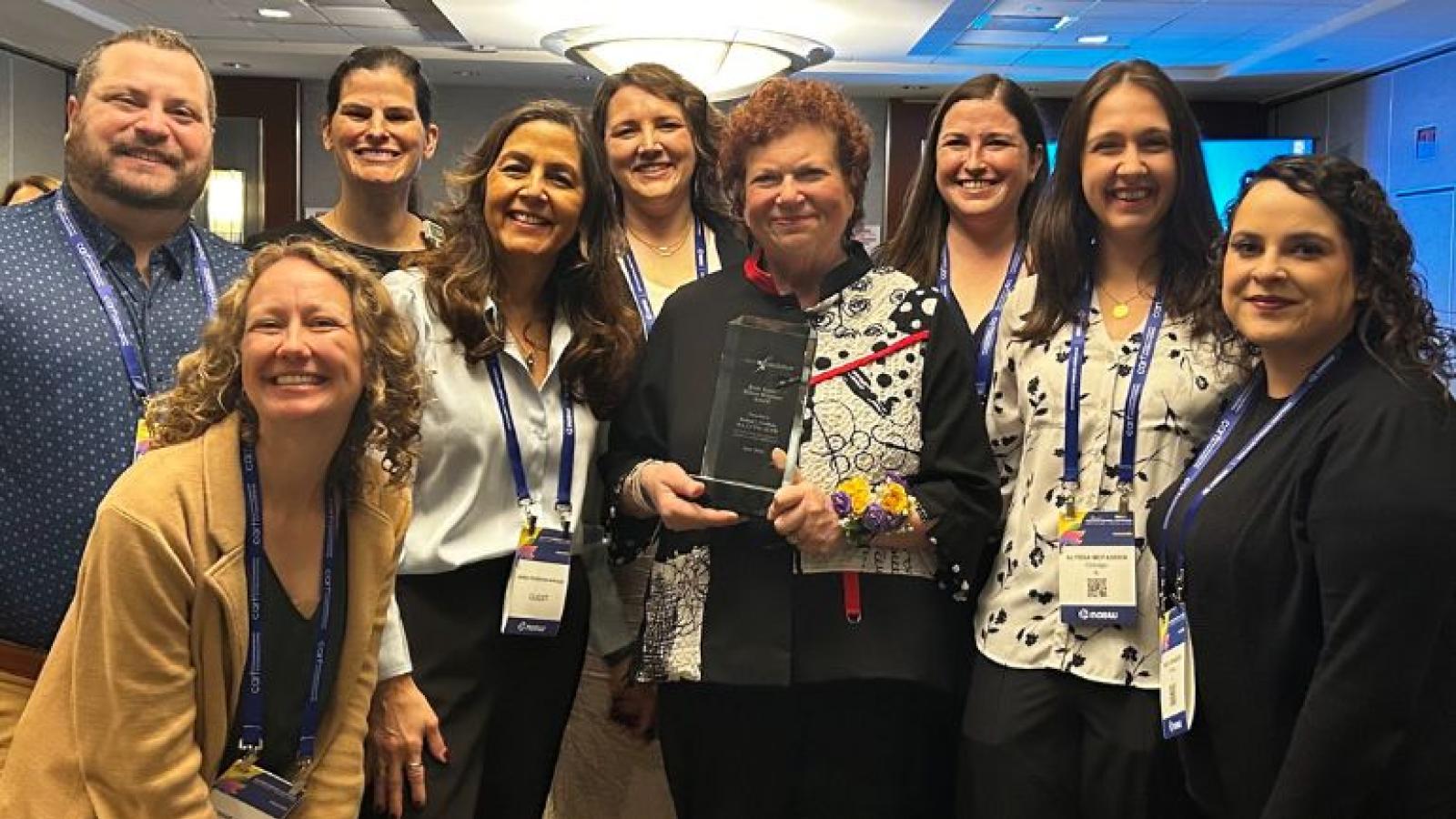 Robyn Golden, LCSW, associate vice president of social work and community health, and Rush team members pose for a photo at an awards ceremony.
