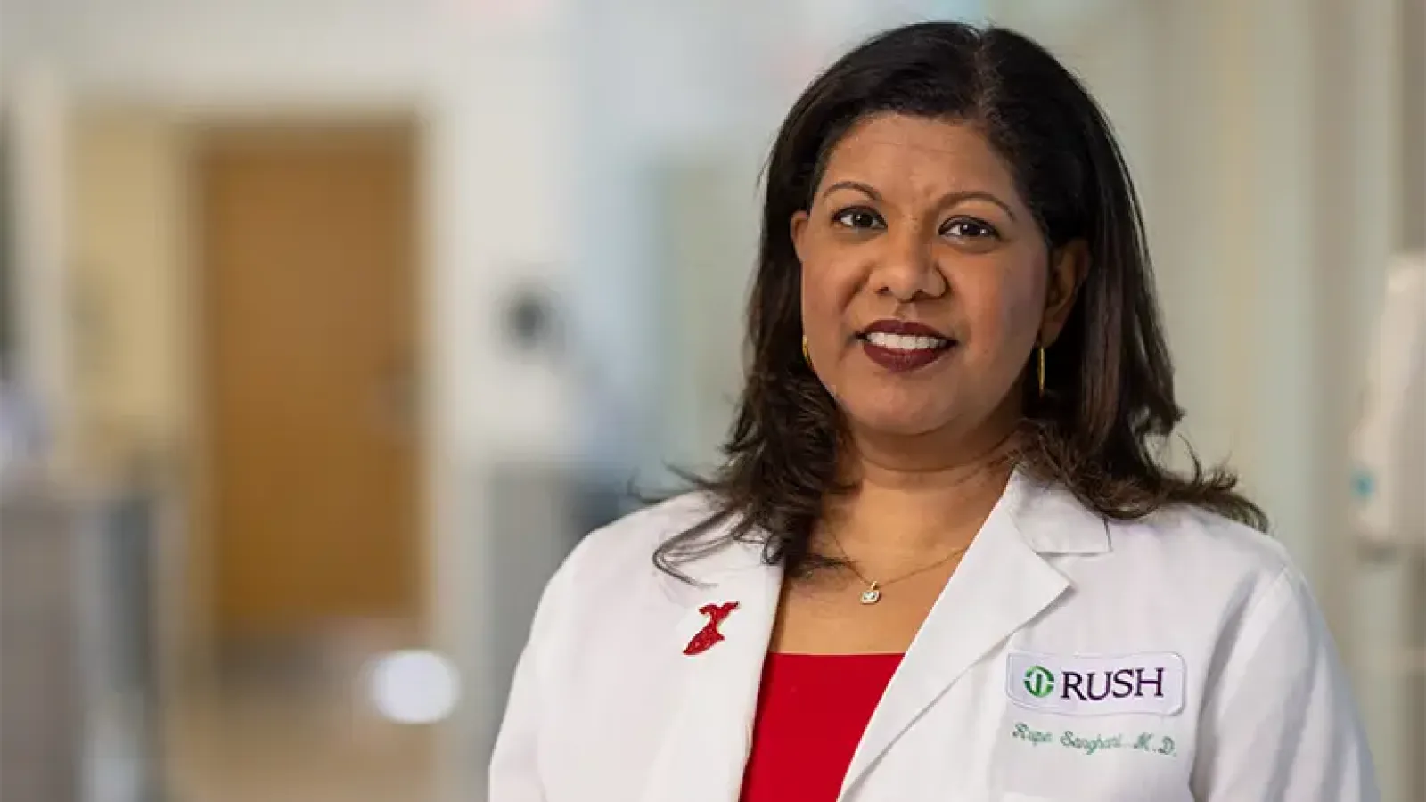 A portrait of Rupa Sanghani, MD, in a white coat.