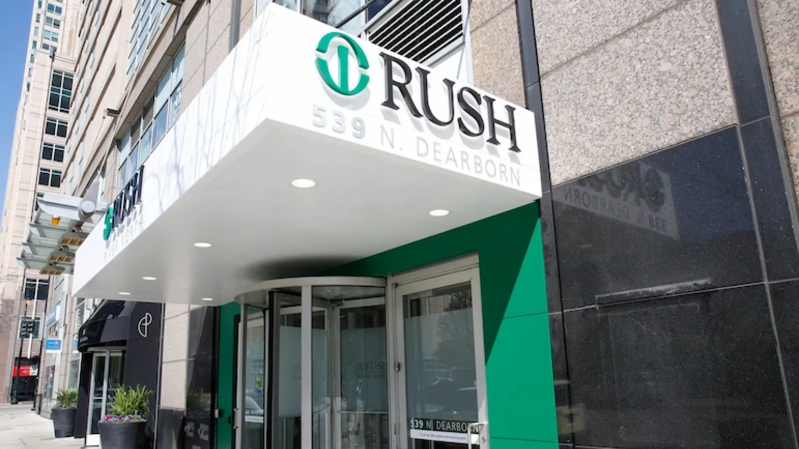 Exterior of Rush Urgent Care in River North. The Rush logo appears on an awning above the entrance.