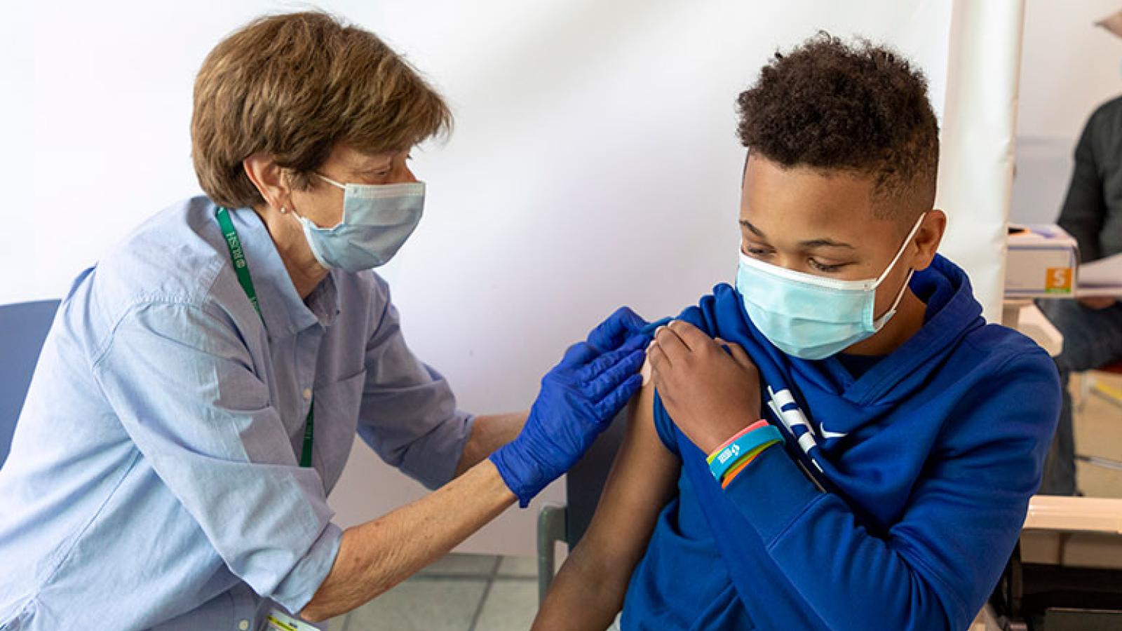 Teen getting vaccinated