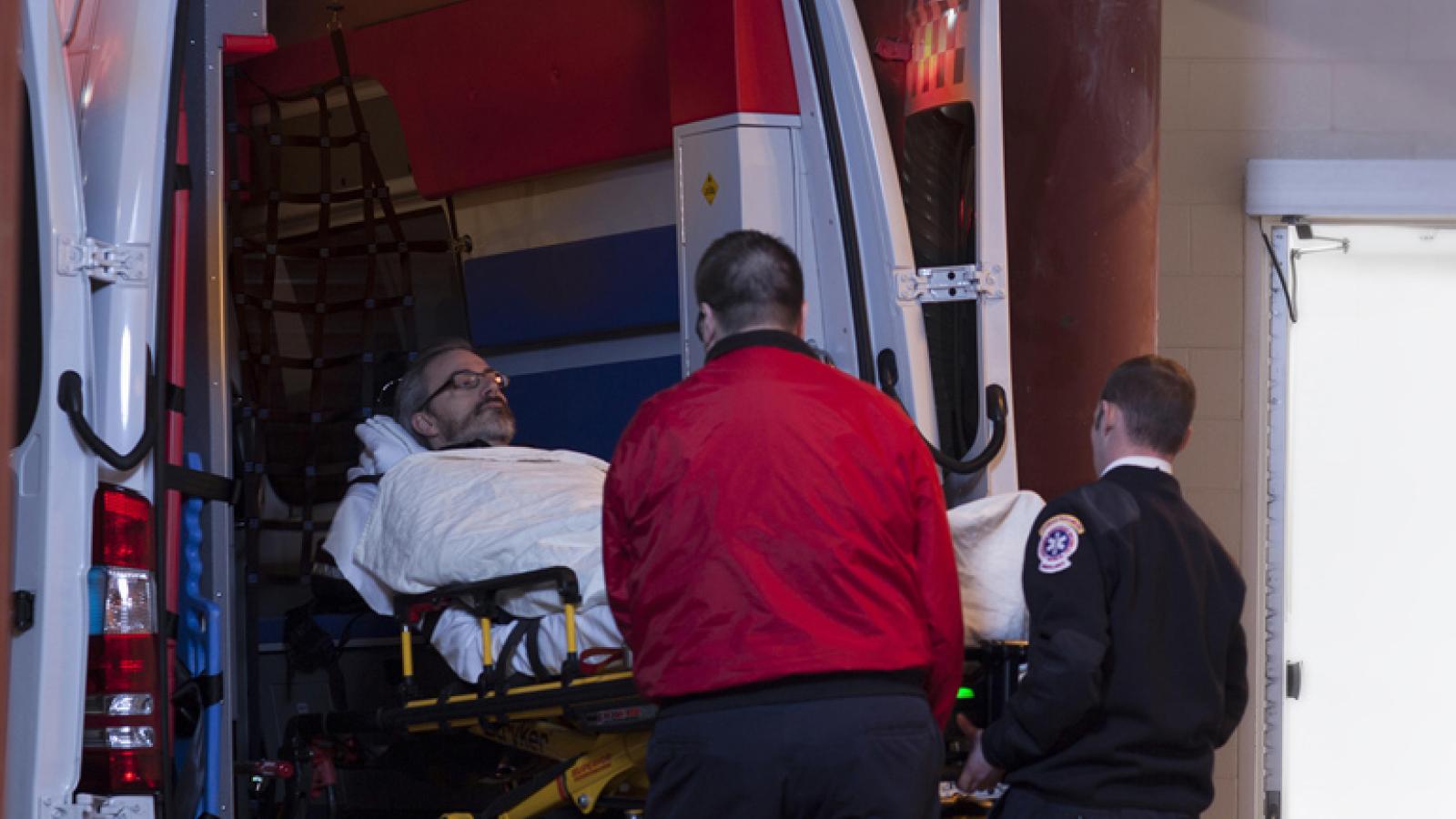 Paramedics with a patient leaving an ambulance