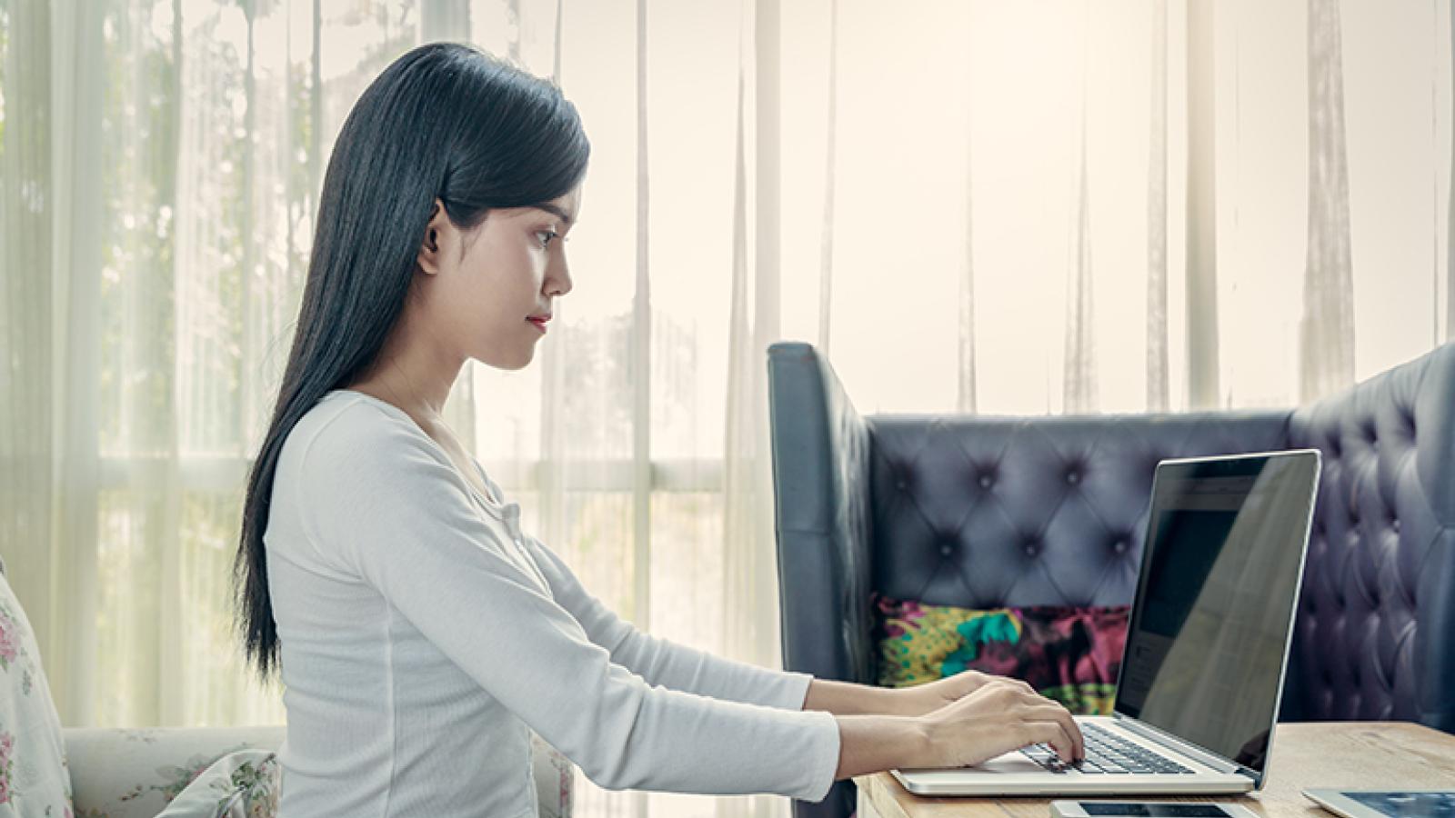 A woman with good posture working on her laptop