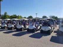 Pictured are a line of golf carts with golfers ready for the Swim Across America Charity Golf Outing.