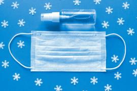 Face Mask and Hand Sanitizer Against Winter Backdrop