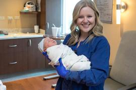 Nurse holds newborn