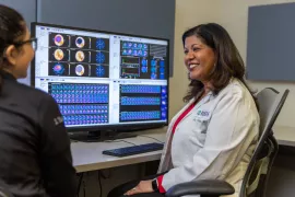 Cardiologist Rupa Sanghani, MD looking at and discussing heart lab imagery.