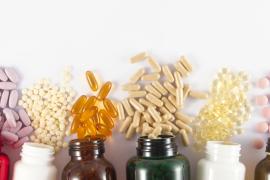 Bottles with different colored pills spilling out