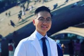 Ben Lee standing in front of the Cloud Gate sculpture