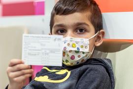 Boy with vaccination certificate