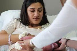 Woman in hospital breastfeeding baby