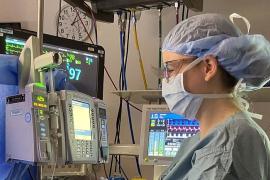 A nurse anesthetist monitors equipment during surgery