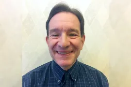 Head shot of David Margolin wearing a blue shirt and tie