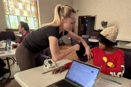 A student takes a woman's blood pressure