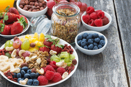 Bowls of fruits and grains on table