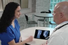 Garrett Katula, DO, with student