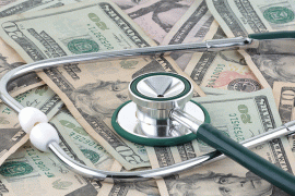 Stethoscope on pile of money