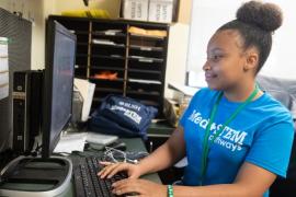 Kyla McDaniel working at a computer