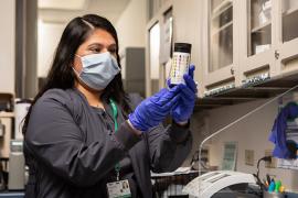 A clinician inspects a medication container