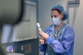 A nurse examines a medication before it's used