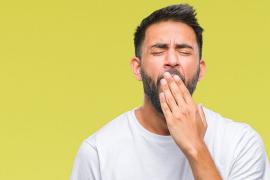 Young man yawning
