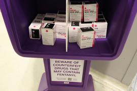 purple newsstand with boxes of narcan inside