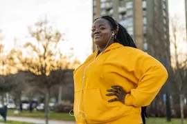 Woman outside exercising and smiling.