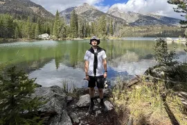 Reese Storr with lake and mountains in background