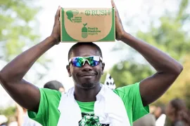 Man holding box of food on head