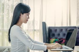A woman with good posture working on her laptop