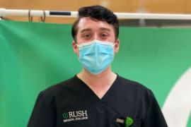 A health care provider wearing a face mask and Rush Medical College scrubs