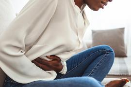 Woman holding her stomach in pain