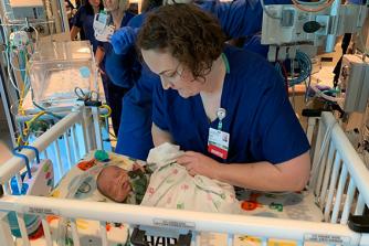 Nurse and baby in NICU