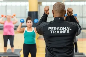 Personal trainer leading exercise class