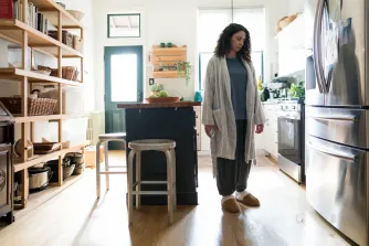 Woman staring at an ice cube on the ground
