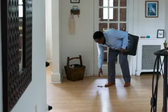 Man picking up keys off the ground