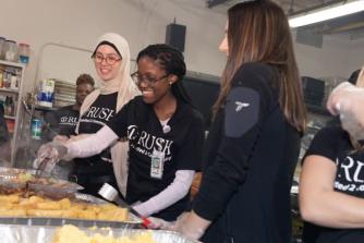 Rush volunteers serving food to the homeless