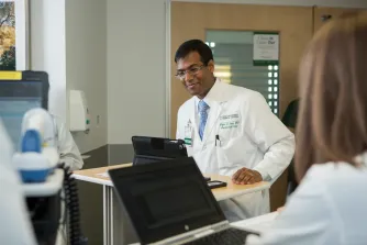 Dr. Garg using a tablet