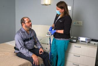A patient getting ready for a sleep study with a sleep medicine provider.