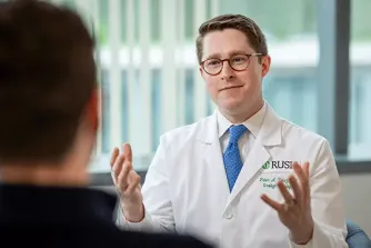 Dr. Peter Reisz speaking with patient
