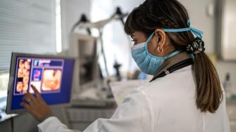 An endoscopist examines a patient