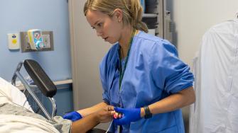 Rush nurse caring for patient in hospital room