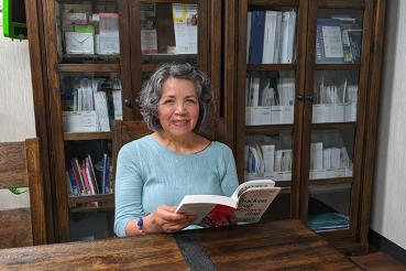 Angelica reads in the library at Waterford Place