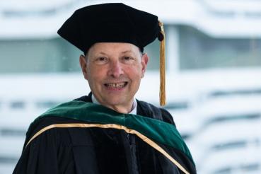 Robert Balk, MD, smiles in his regalia as university marshal.