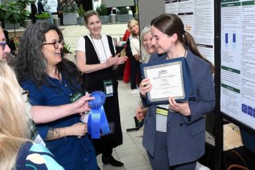 Rush University alumni present their research posters.