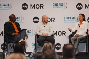 Three seated individuals have a discussion at the 2025 Chicago Sports Summit.